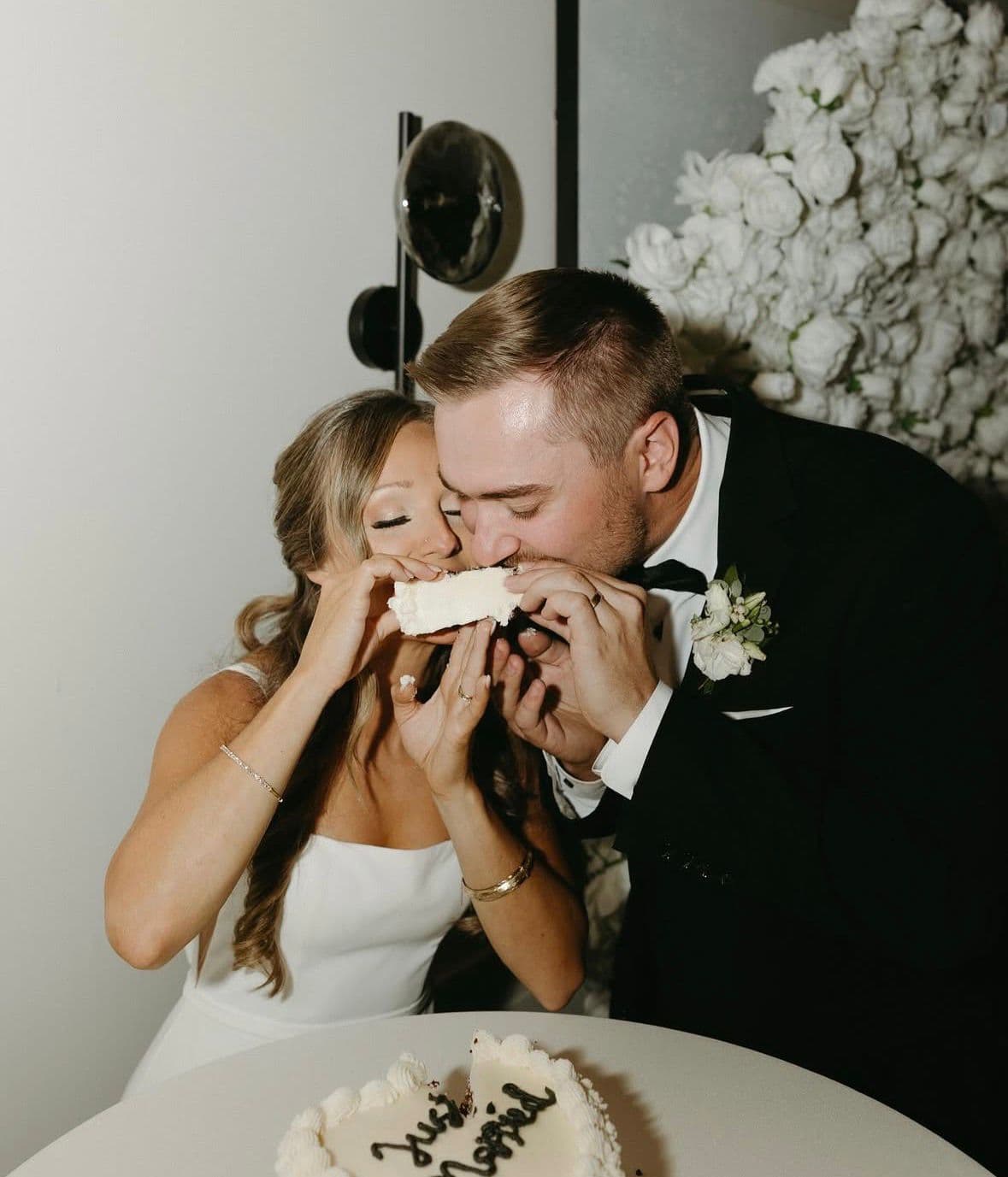 Bride and groom sharing wedding cake